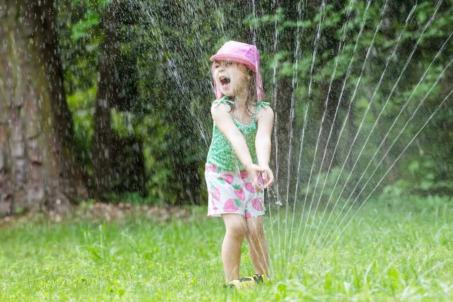 playing in sprinkler