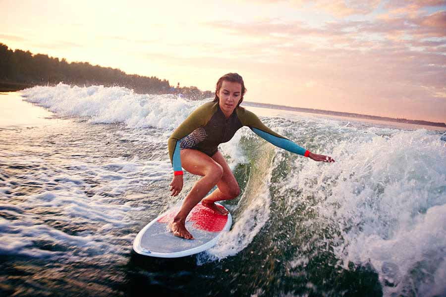 girl surfing at the beach