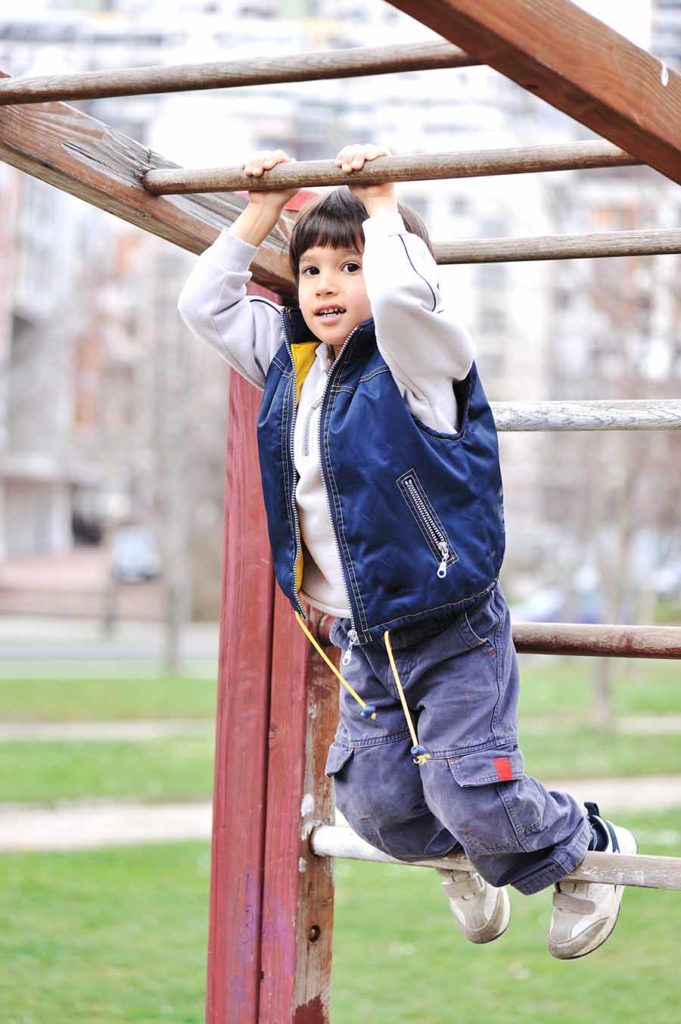 son on monkey bars