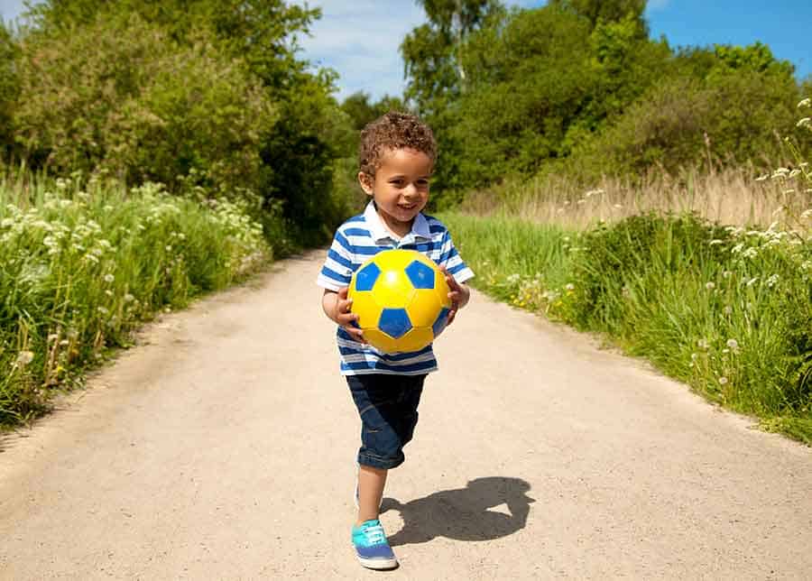 child playing with toy outside