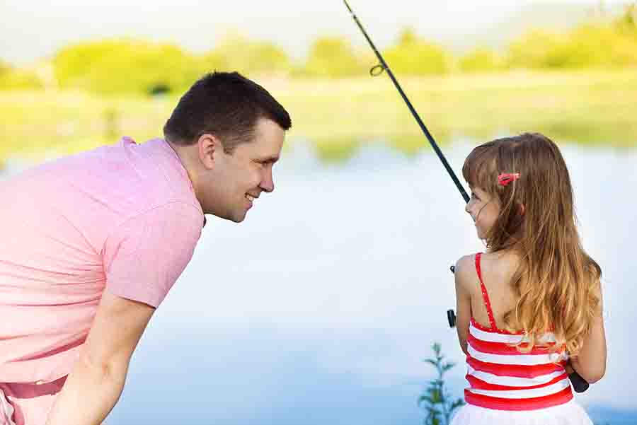 dad fishing with young daughter