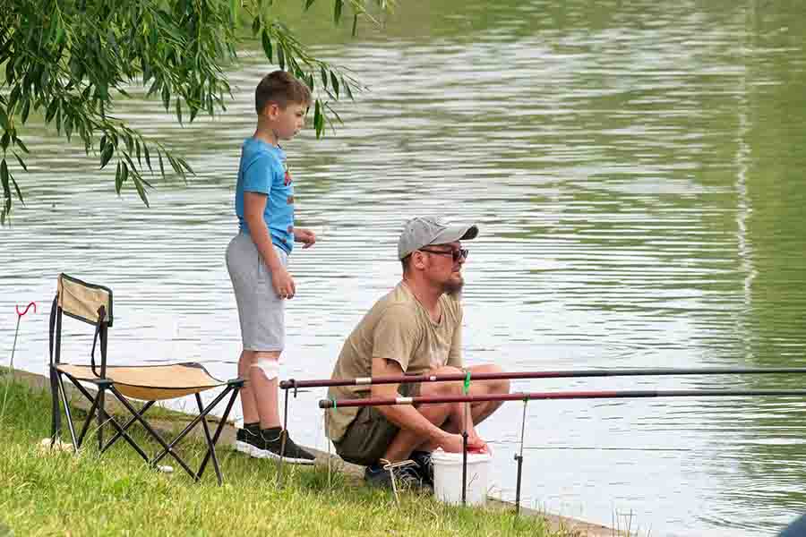 dad and kid fishing on river