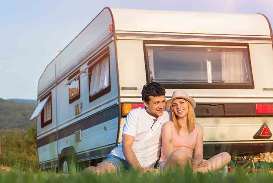 couple in front of camper