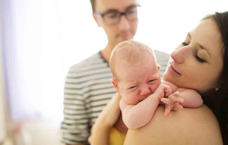 parents holding newborn