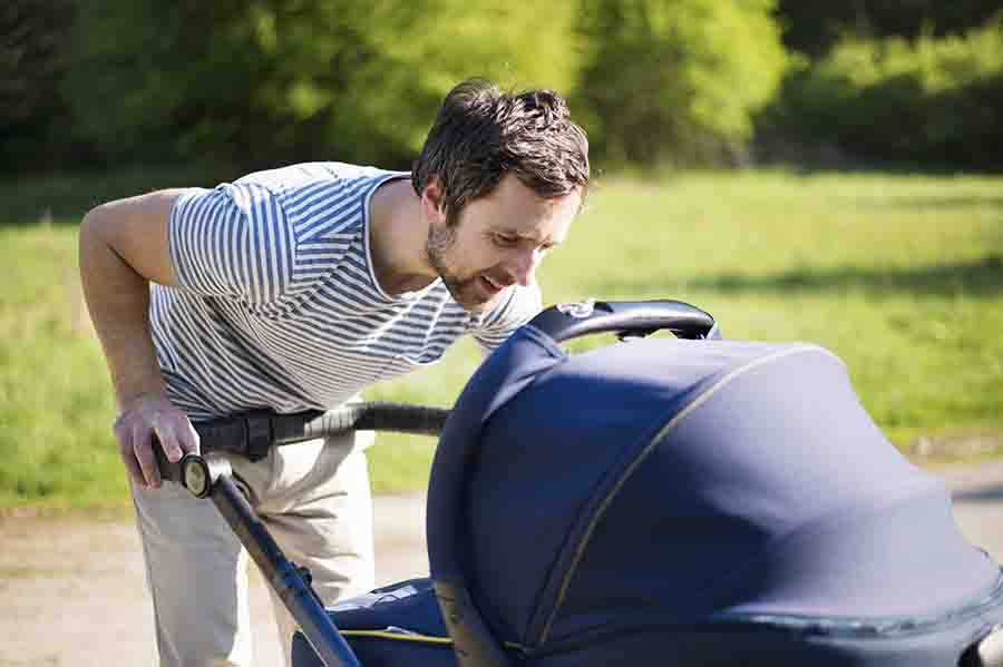 parent push child in stroller