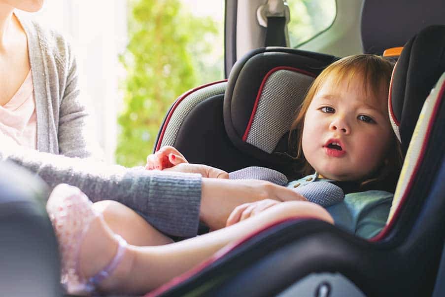 toddler in car with parent